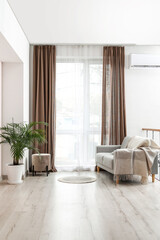 Interior of stylish living room with light curtains