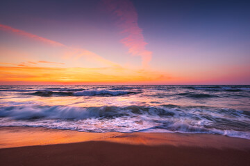 Naklejka na ściany i meble Beach sunrise over the sea
