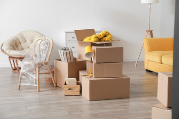 Cardboard boxes with belongings in room on moving day