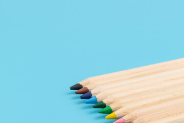 Wooden colorful ordinary pencils isolated on blue background. Back to school