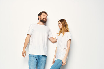joyful man and woman in white t-shirts embrace friendship together