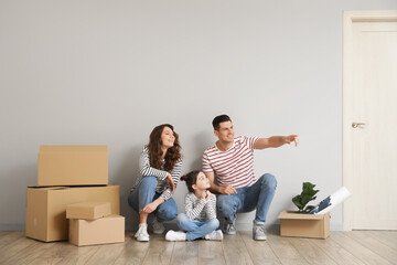 Happy family with moving boxes in their new house