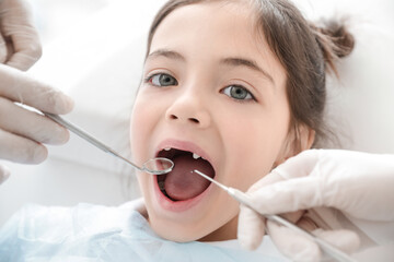 Little girl visiting dentist in clinic, closeup