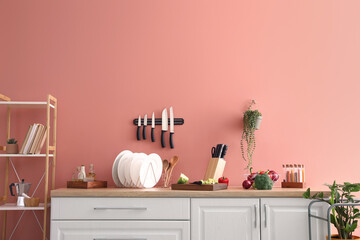 Counter with vegetables and utensils in kitchen
