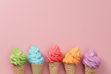 Various of colourful meringue ice cream cone on pink background for sweet and refreshing dessert...