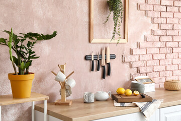 Fototapeta na wymiar Counter with food and kitchen utensils near color wall
