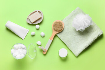 Bath supplies and massage brush on color background