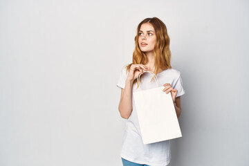 cute red-haired woman in white t-shirt packs shopping lifestyle