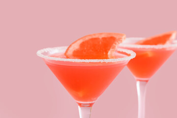 Glasses of Hemingway daiquiri cocktail on color background, closeup