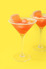Glasses of Hemingway daiquiri cocktail on color background