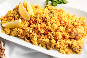 Plate with tasty pilaf on table, closeup