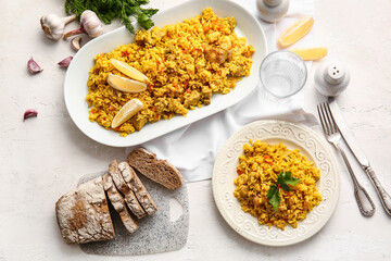 Composition with tasty pilaf on light background