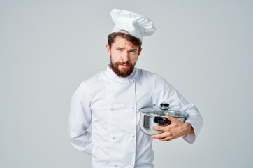 professional chef with pan in hand cooking food kitchen light background