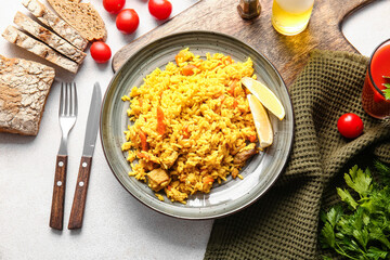 Composition with tasty pilaf on light background
