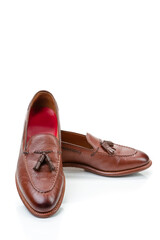 Footwear Concepts. Pair of Traditional Formal Stylish Brown Pebble Grain Tassel Loafer Shoes On...