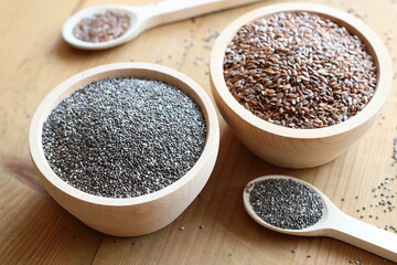 Flaxseed and chia seeds in wooden bowls

