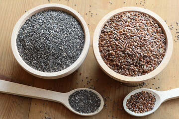 Flaxseed and chia seeds in wooden bowls

