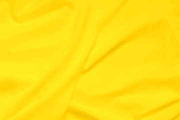 Soft focus yellow smooth ripple linen fabric texture background, yellow is the color trend of 2021 that represents freshness, vitality, optimism and hope