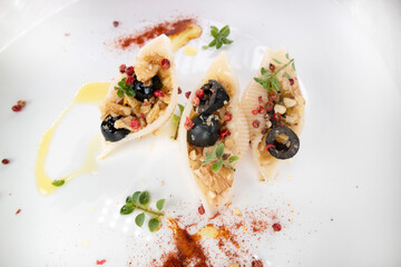 Pasta shells with olive and walnut sauce in olive oil