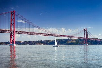 Portugal Travel Ideas. One Sailing Boat With Group of Tourist on Tagus River Under 25th of April Bridge in Lisbon in Portugal