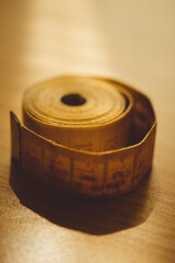 Old yellow measuring tape on the table