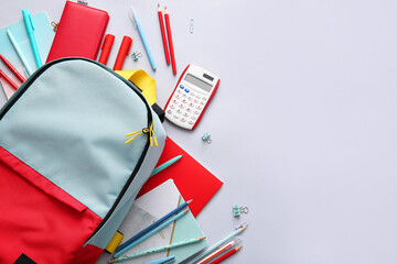 Fototapeta School backpack and stationery on light background obraz