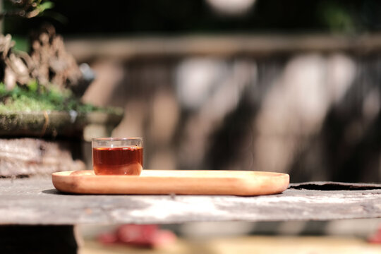 Romantic morning. Wooden tea table, tea cup. Interior green tones. High quality photo