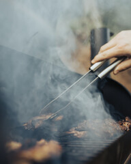 Vertical shot of barbecue with smoke on the grill