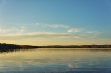 Fototapeta na wymiar Sunset on the lake under the blue sky 