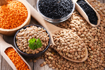 Fototapeta premium Composition with three sorts of lentils on wooden table