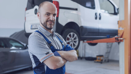 Professional mechanic posing in the auto repair shop