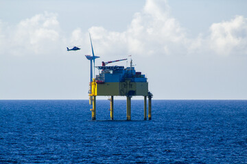 Helicopter approaching a transformer platform at an offshore wind farm