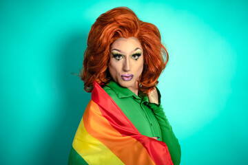 Happy drag queen celebrating gay pride holding rainbow flag - LGBTQ social community concept
