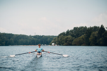 Sportsman single scull man rower rowing at competition boat regatta. Olympic games sport
