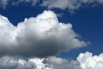 White clouds in a bright blue sky. A sunny day