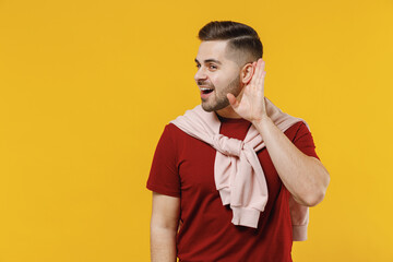 Young fun curious nosy man 20s wearing red t-shirt casual clothes try to hear you overhear...