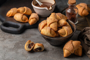 Filled pastries - rugelach or kipferl. Made with butter and cream cheese doughs with hazelnut chocolate cream.