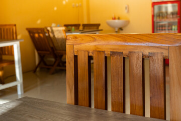 Dining table by the window with wooden chairs.