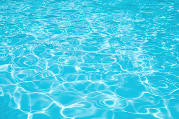 Fototapeta na wymiar Blue water in swimming pool with sun reflection