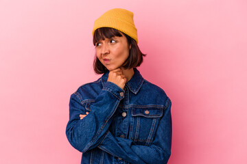 Young mixed race woman isolated on pink background suffers pain in throat due a virus or infection.