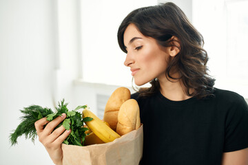 woman with a package of groceries healthy food cooking shopping