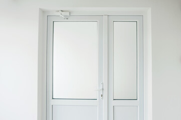 Photo of new white plastic door in office with diffused glass