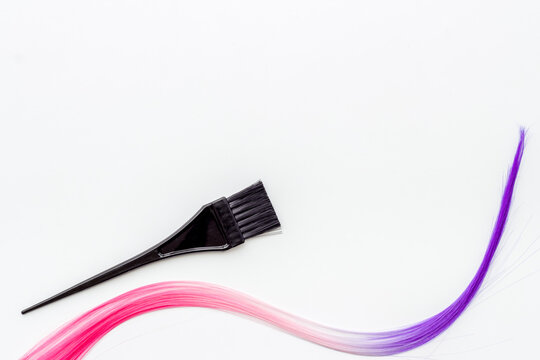 Brush and strand of coloring hair. Hair dye concept