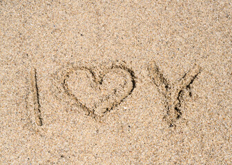 The inscription I love you on the sand