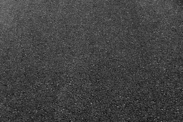 Close up of local black asphalt road surface texture. Selective focus.