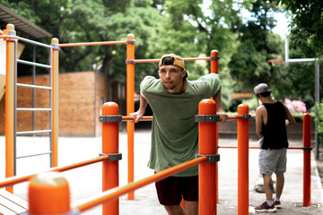 Fototapeta premium male person doing sport exercise on the parallel bars