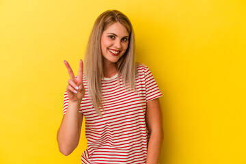 Young russian woman isolated on yellow background showing number two with fingers.