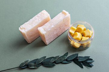 Body massage tiles made of natural cocoa butter and aromatic oils in a jar. A bar of natural handmade citrus soap. Care for dry skin of the body. Home spa. Small business