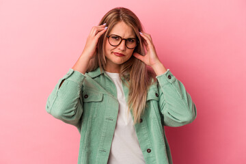 Young russian woman isolated on pink background crying, unhappy with something, agony and confusion concept.