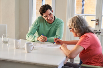 Obraz premium Young man and elderly woman with dementia solving maze puzzles